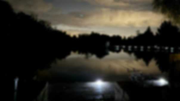 Night fishing Fishing at night with the lake in darkness