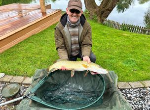 A fisherman with a fish he has caught