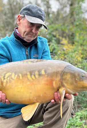 A fisherman with a caught fish in his hands