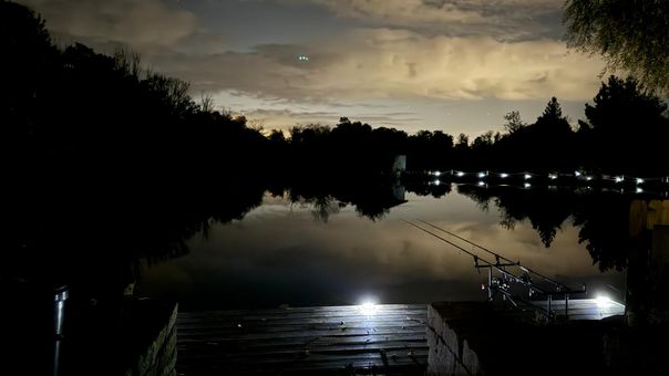 Fishing at night with the lake in darkness