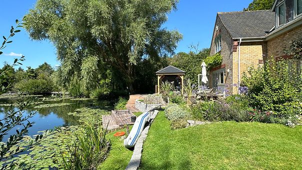 A photo of the house next to the lake.