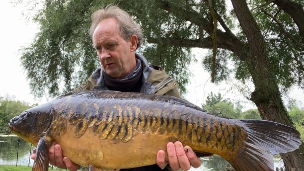 A person holding a caught fish