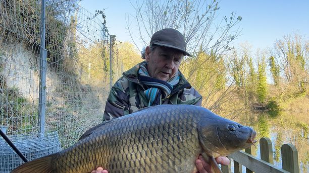 A person holding a caught fish on a chilly day